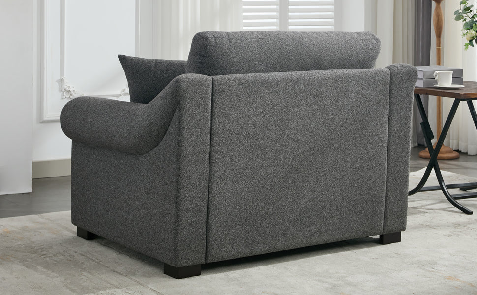 Dark grey textured fabric armchair with rolled arms and plush cushioning