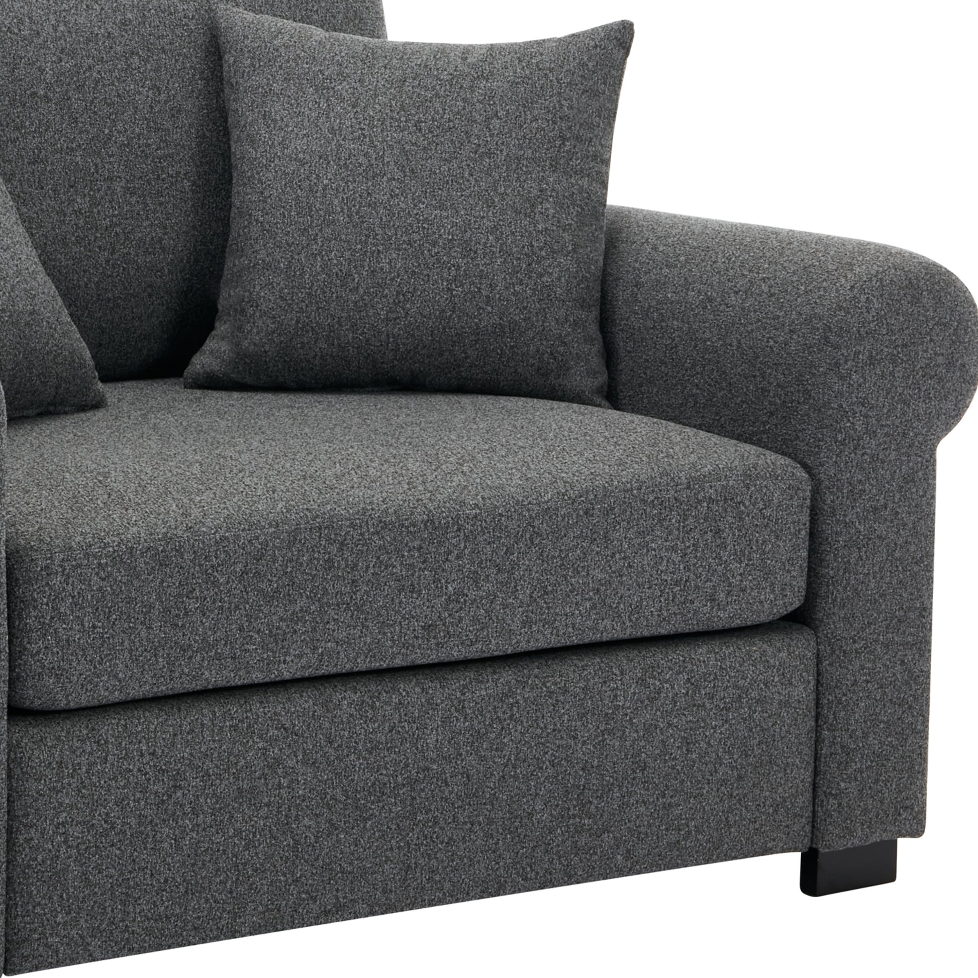 Modern charcoal gray upholstered sofa with plush cushions and sleek black legs