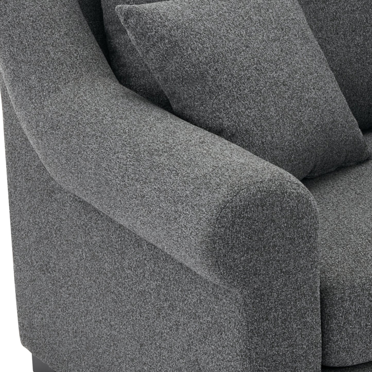 Closeup of a dark gray textured fabric sofa armrest with a matching cushion