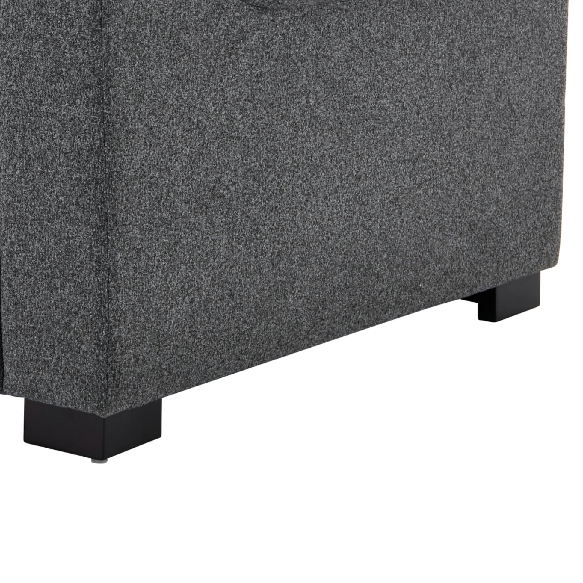 Closeup of textured dark gray fabric upholstery on a modern sofas base
