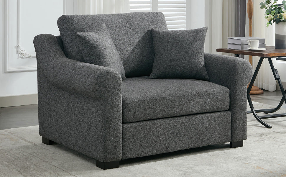 Comfortable charcoal grey fabric armchair with plush cushions and rolled arms perfect for relaxing