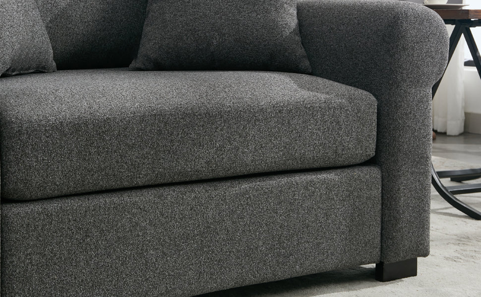 Textured charcoal grey fabric sofa detail with plush cushions and squared arms