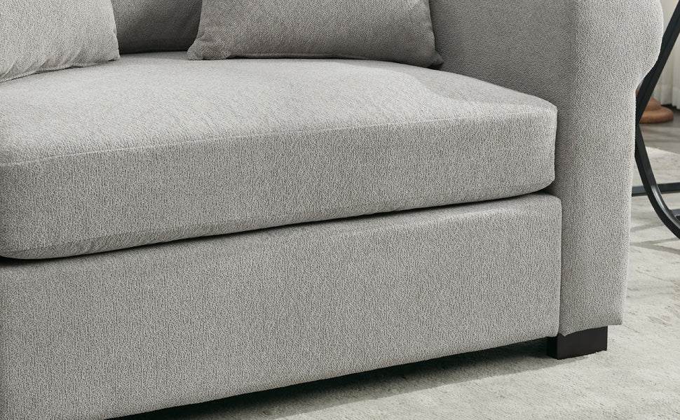 Closeup of a plush grey textured sofa showcasing deep seat cushions perfect for lounging