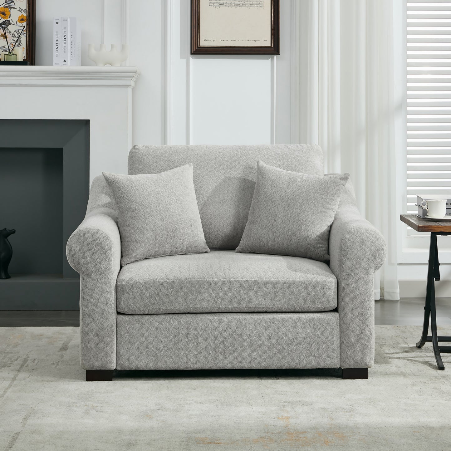 Plush grey fabric armchair with two throw pillows perfect for a modern living room