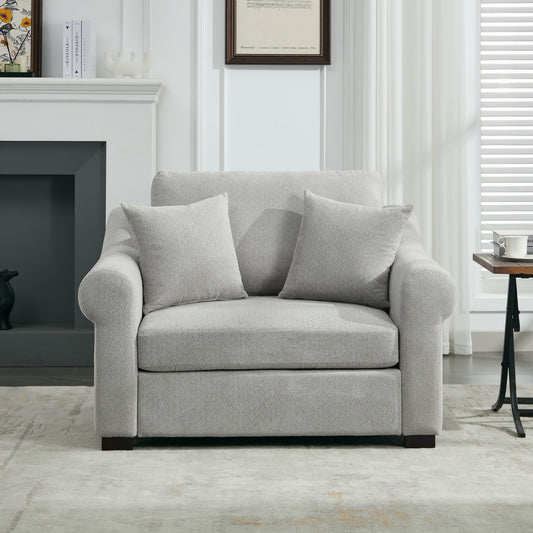 Plush grey fabric armchair with two throw pillows perfect for a modern living room