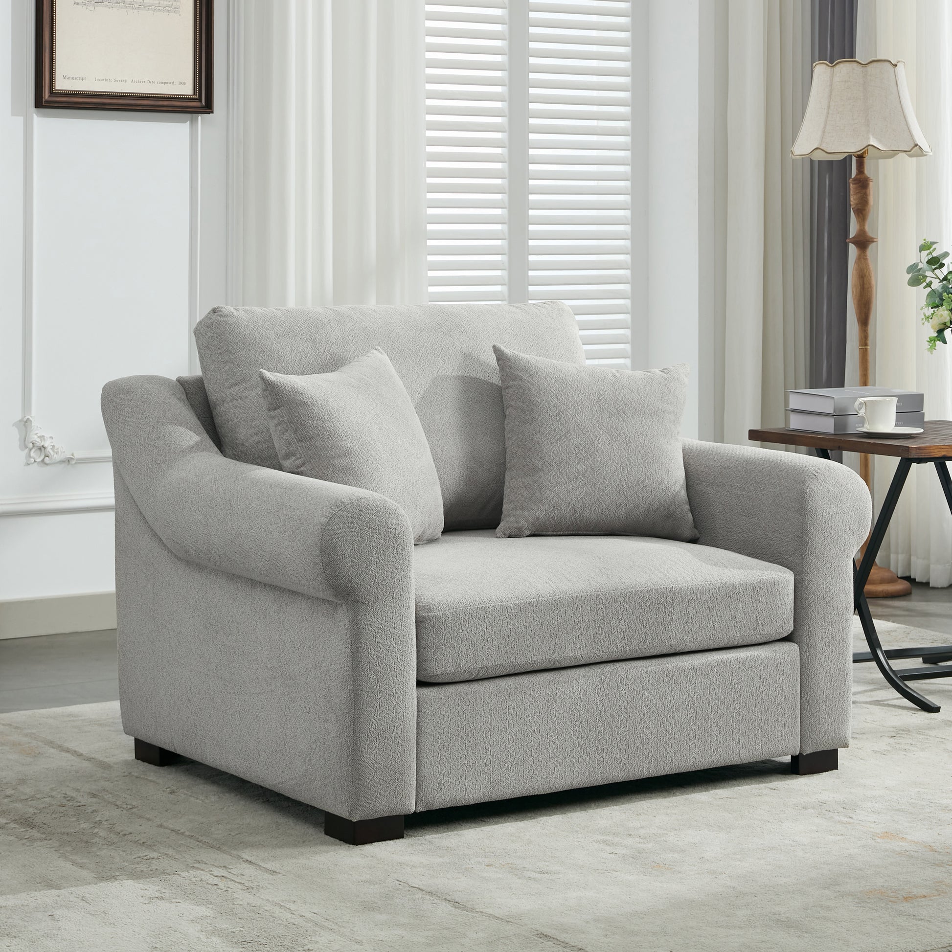 Plush grey upholstered loveseat with rolled arms and two throw pillows perfect for living room comfort