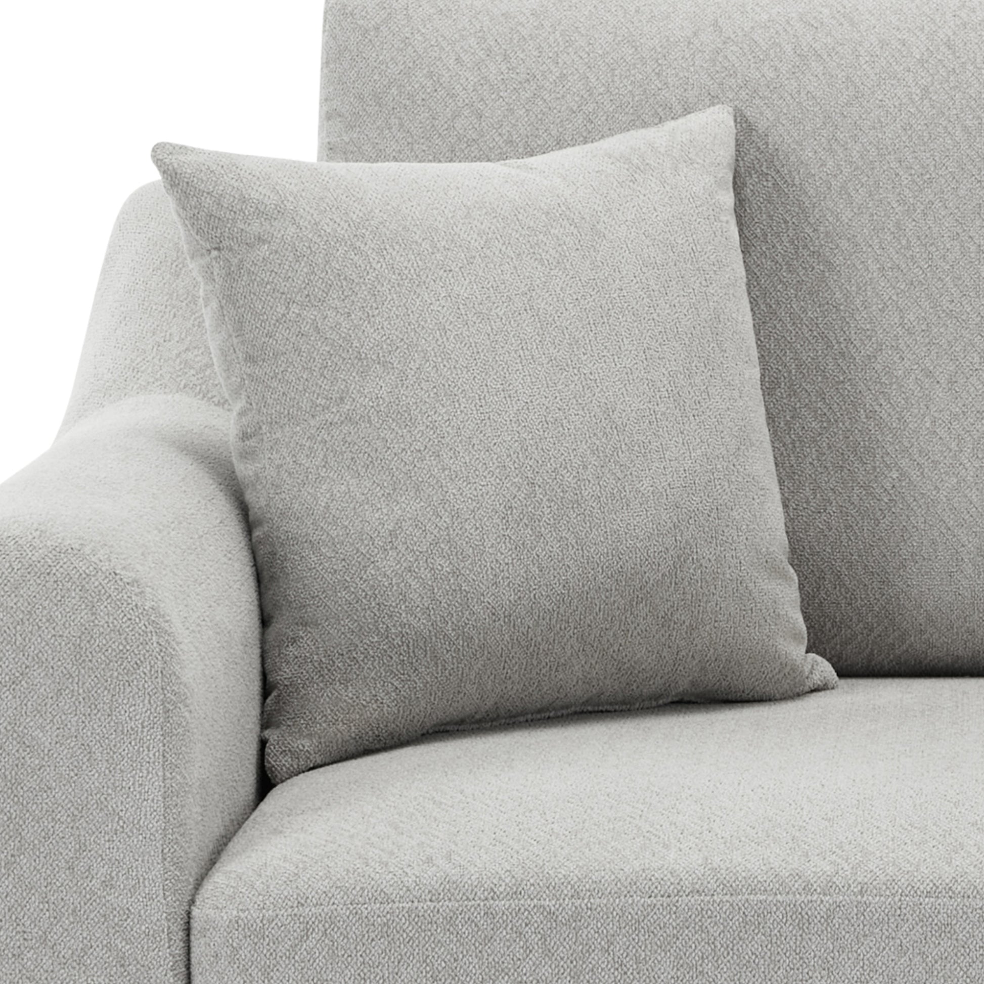 Light grey textured throw pillow on a matching sofa offering comfort and style