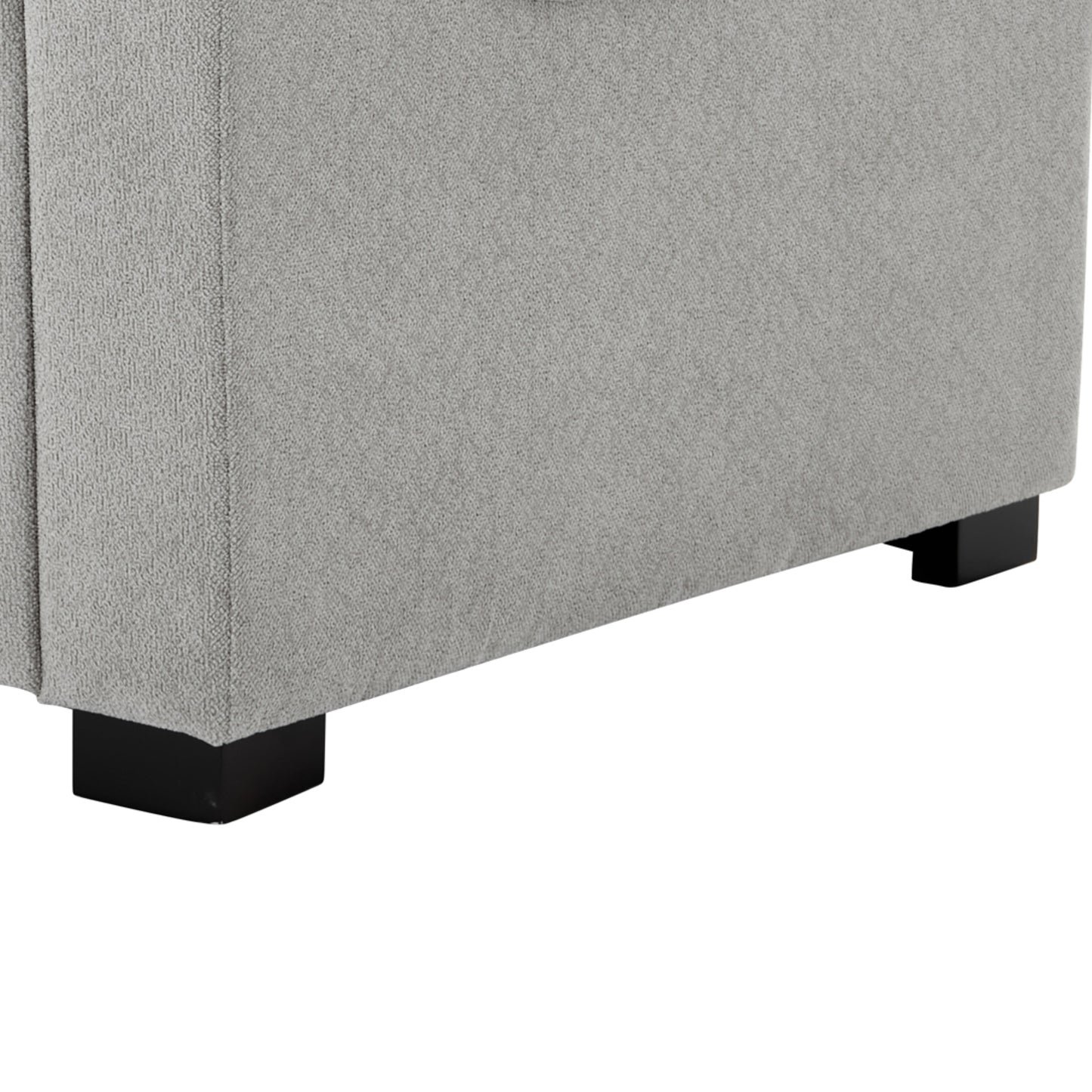 Closeup of textured gray fabric upholstery on a sofa with dark wooden legs
