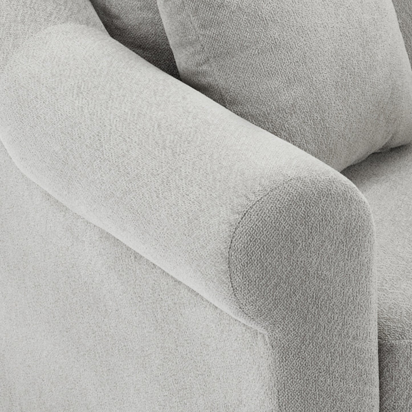 Closeup of a textured gray linen sofa armrest offering plush comfort and style