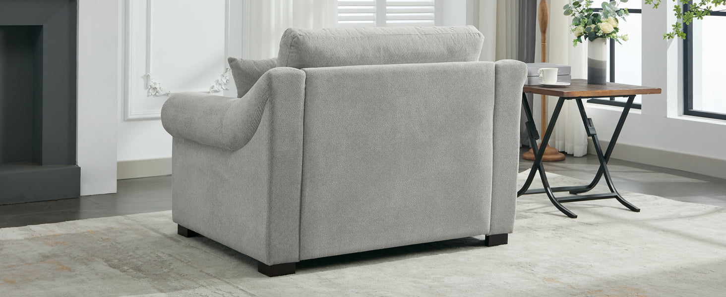 Textured light gray fabric armchair with plush back cushions and rolled arms