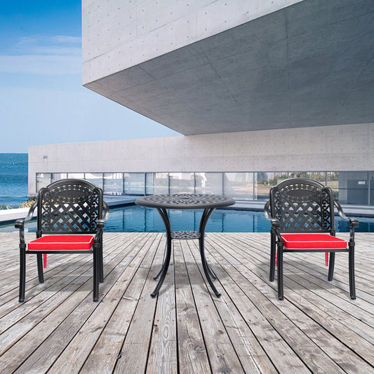 Black ornate metal patio dining set with red cushions