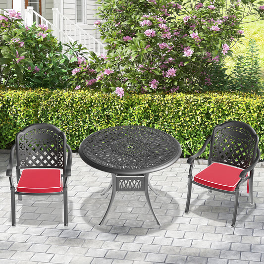 Black ornate cast aluminum patio set with two chairs and a round table featuring red cushions