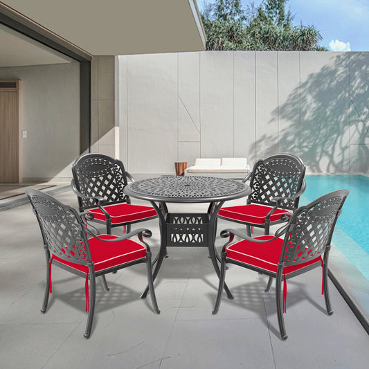Black cast aluminum patio dining set with four red cushioned chairs and round table