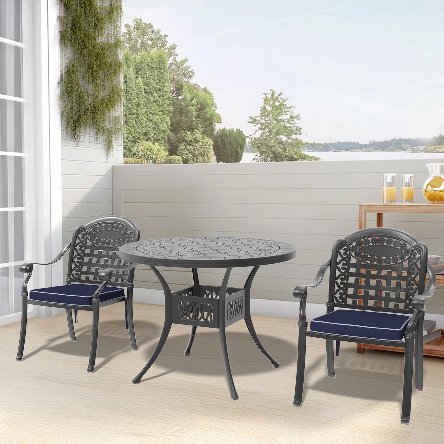 Dark gray cast aluminum bistro set with navy cushions on a patio setting