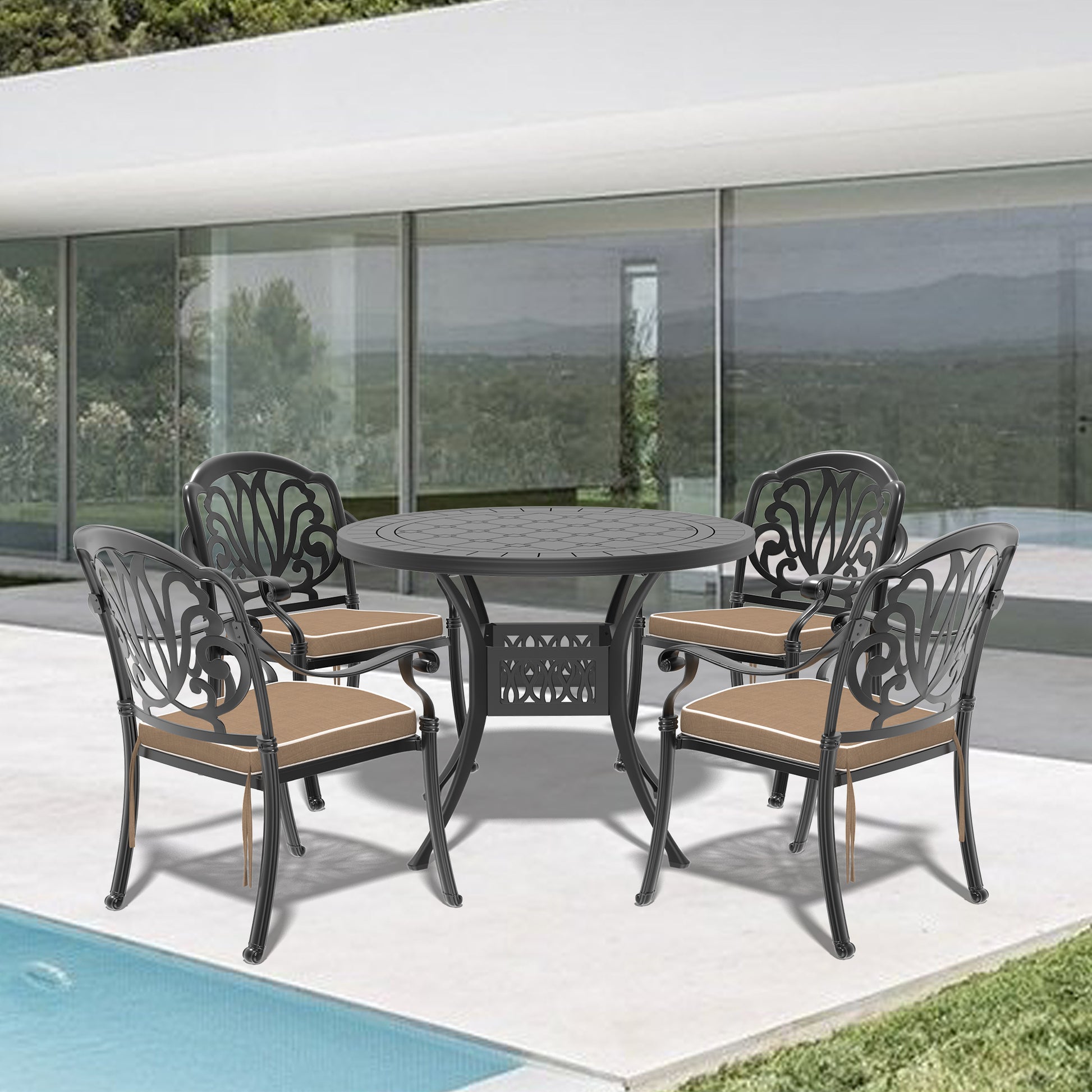 Black cast aluminum patio dining set with ornate chairs and round table