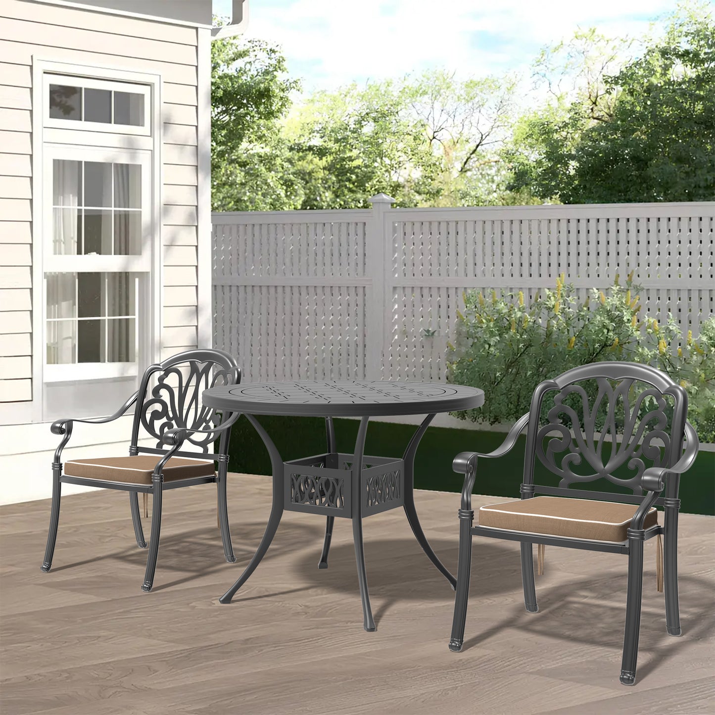 Ornate dark gray cast aluminum patio dining set with two chairs and round table on wooden deck