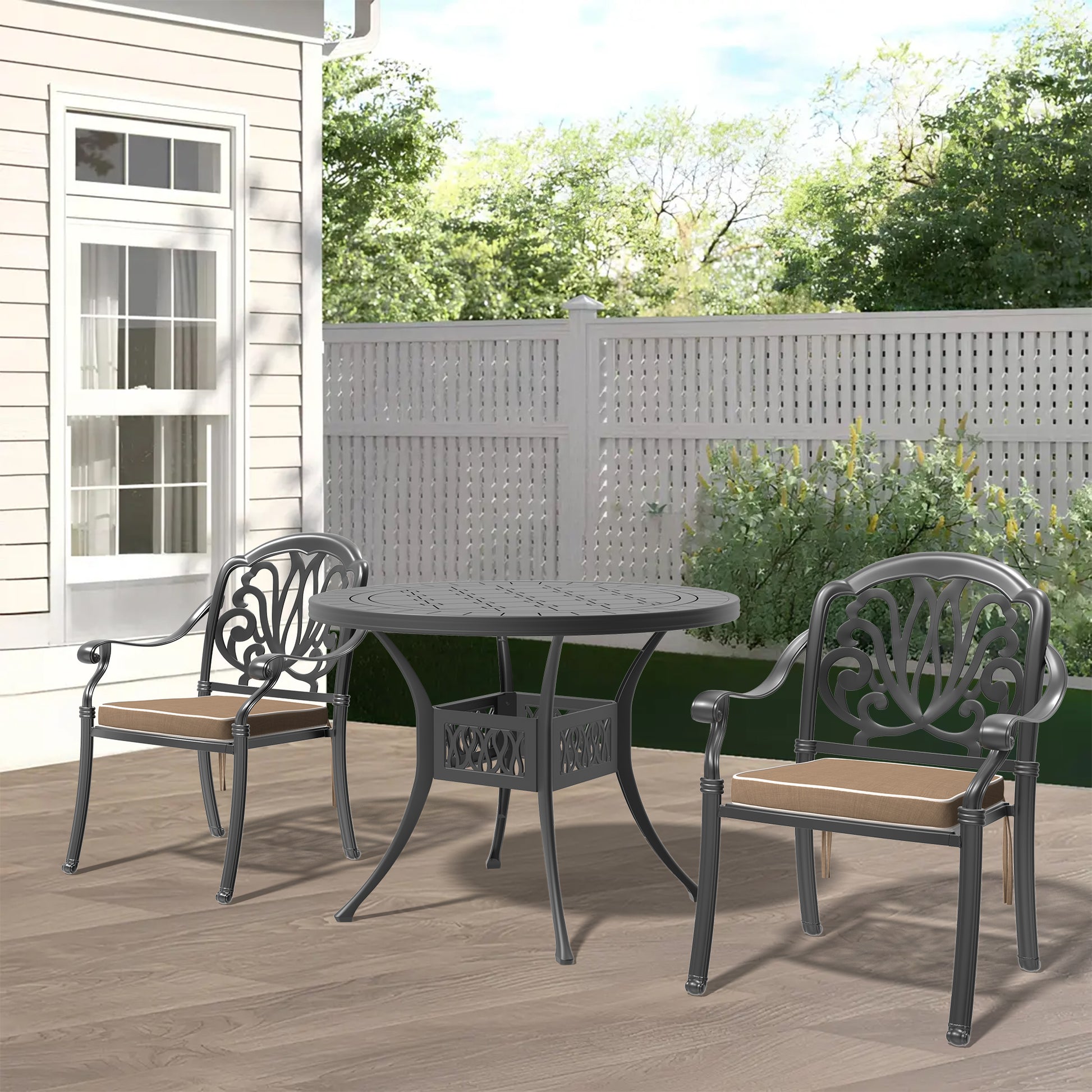 Ornate dark gray cast aluminum patio dining set with two chairs and round table on wooden deck