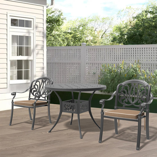 Ornate dark gray cast aluminum patio dining set with two chairs and round table on wooden deck