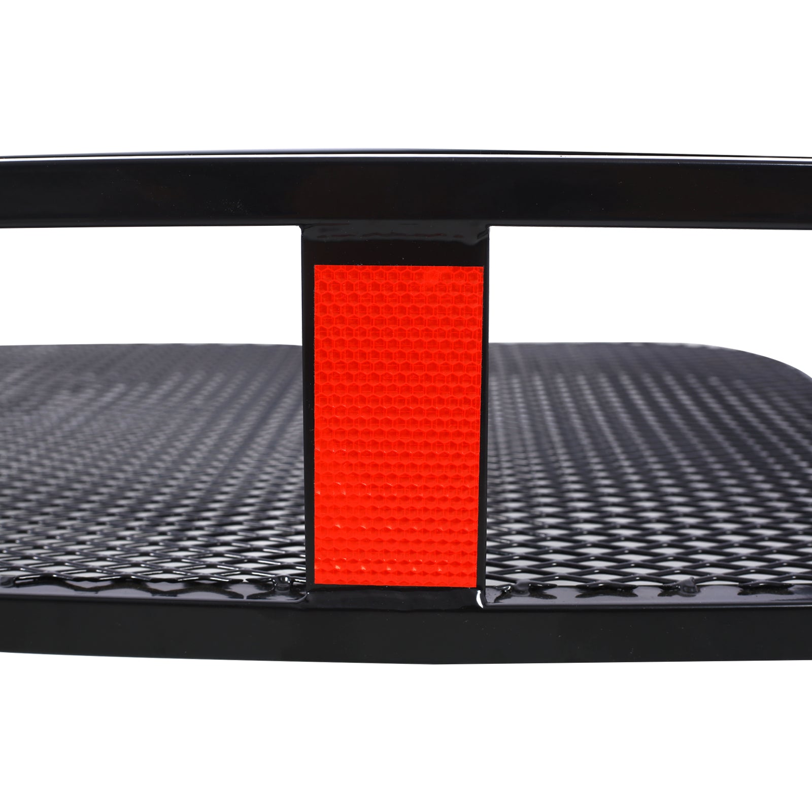 Close up of black metal trailer ramp with red reflector