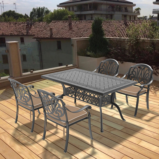 Ornate cast aluminum patio dining set with rectangular table and four chairs
