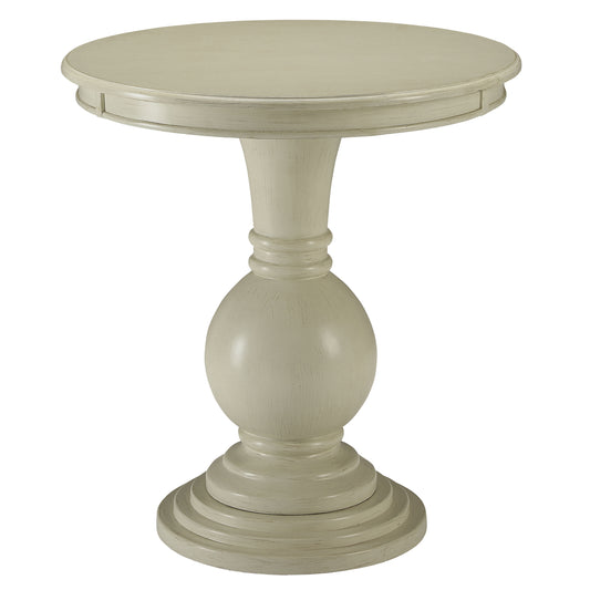 Antique white round pedestal accent table with carved details and a distressed finish