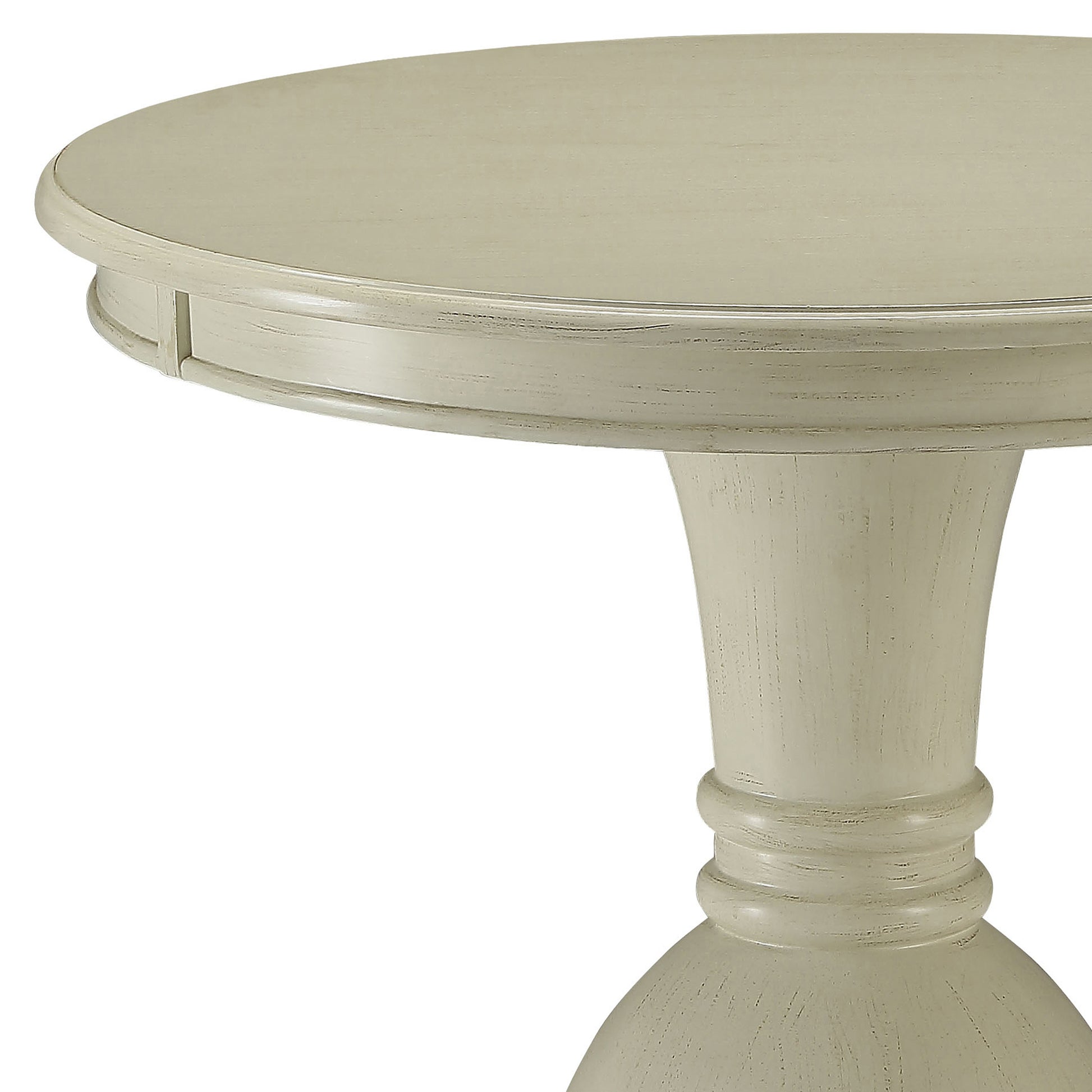 Light beige round pedestal dining table with distressed finish
