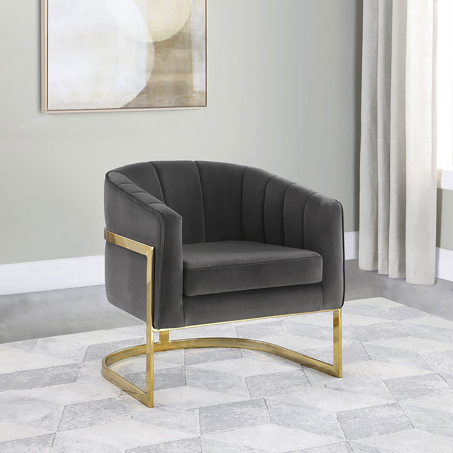 Dark gray velvet accent chair with vertical channel tufting and gold metal legs