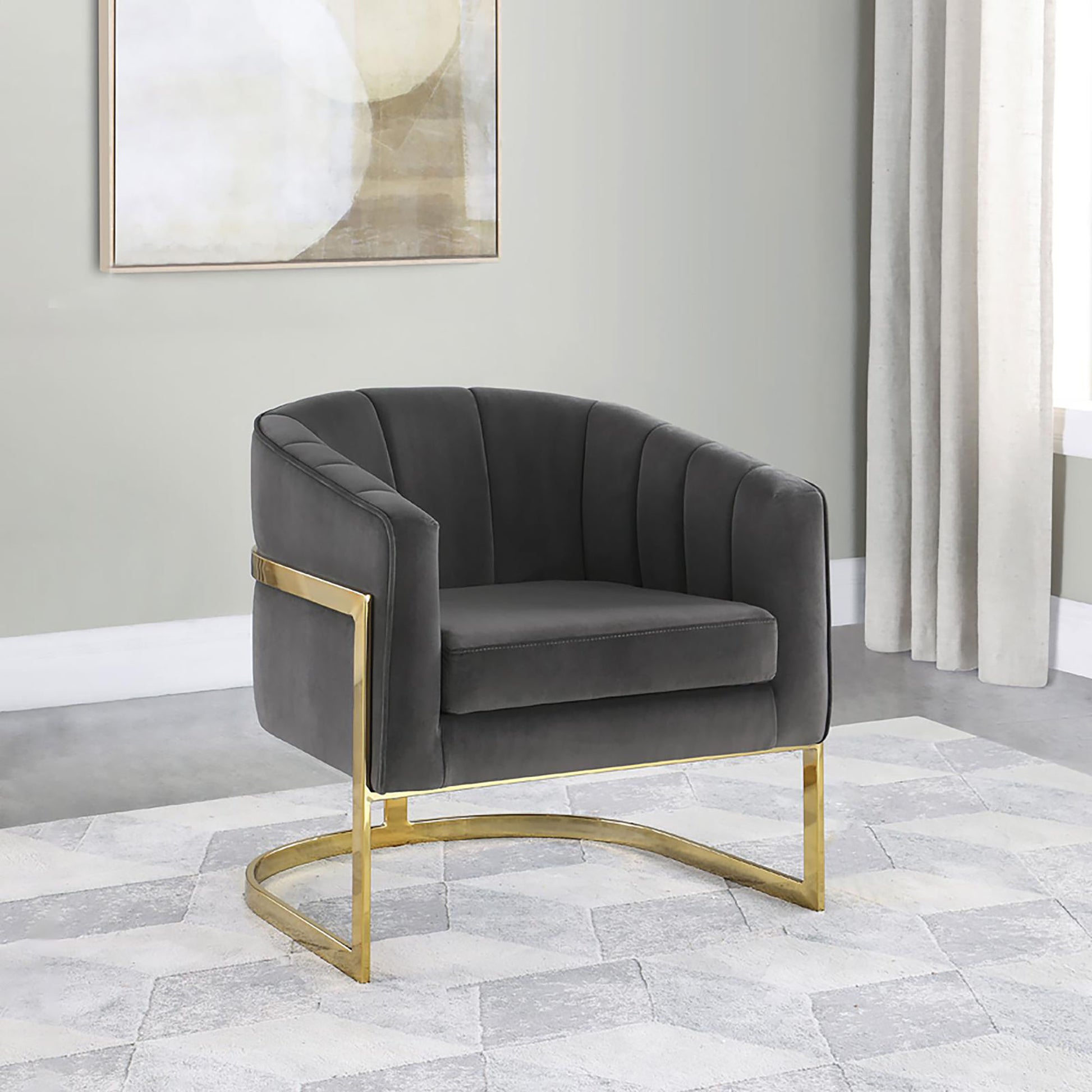 Dark gray velvet accent chair with vertical channel tufting and gold metal legs