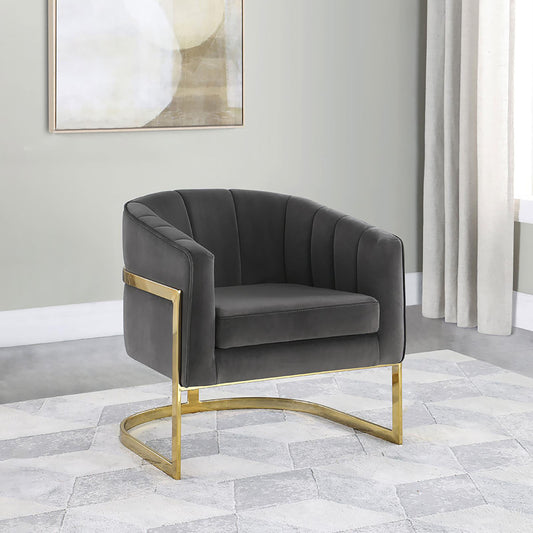 Dark gray velvet accent chair with vertical channel tufting and gold metal legs