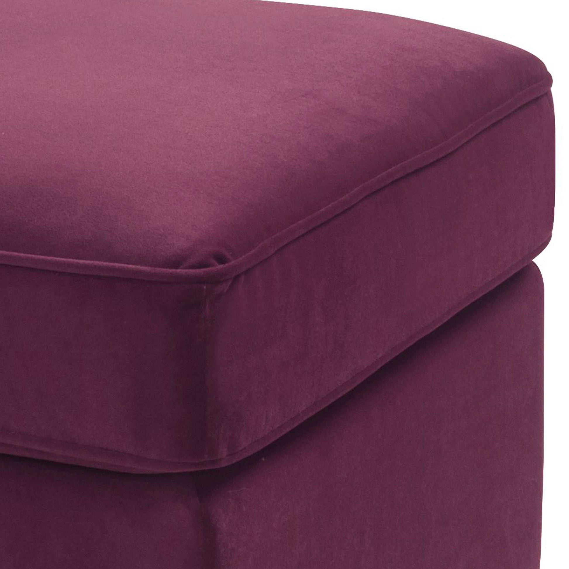 Plush deep plum velvet ottoman with piped edges perfect for footrest or extra seating