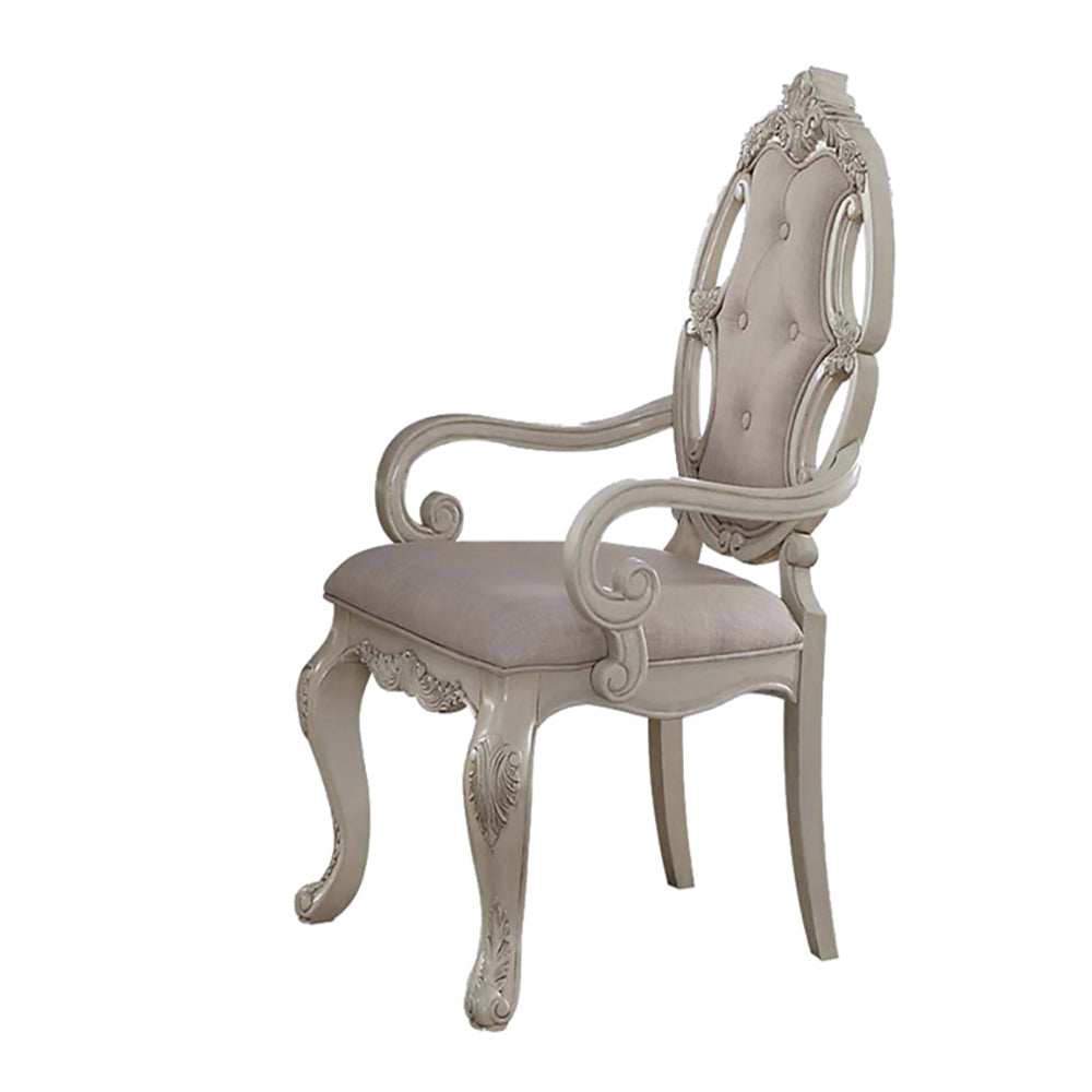 Elegant antique dining chair with ornate carved details and upholstered seat in antique white