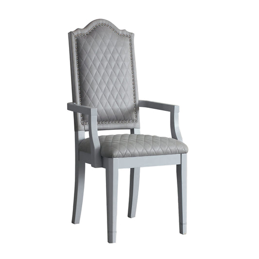 Elegant grey upholstered dining chair with diamond tufting and silver nailhead trim