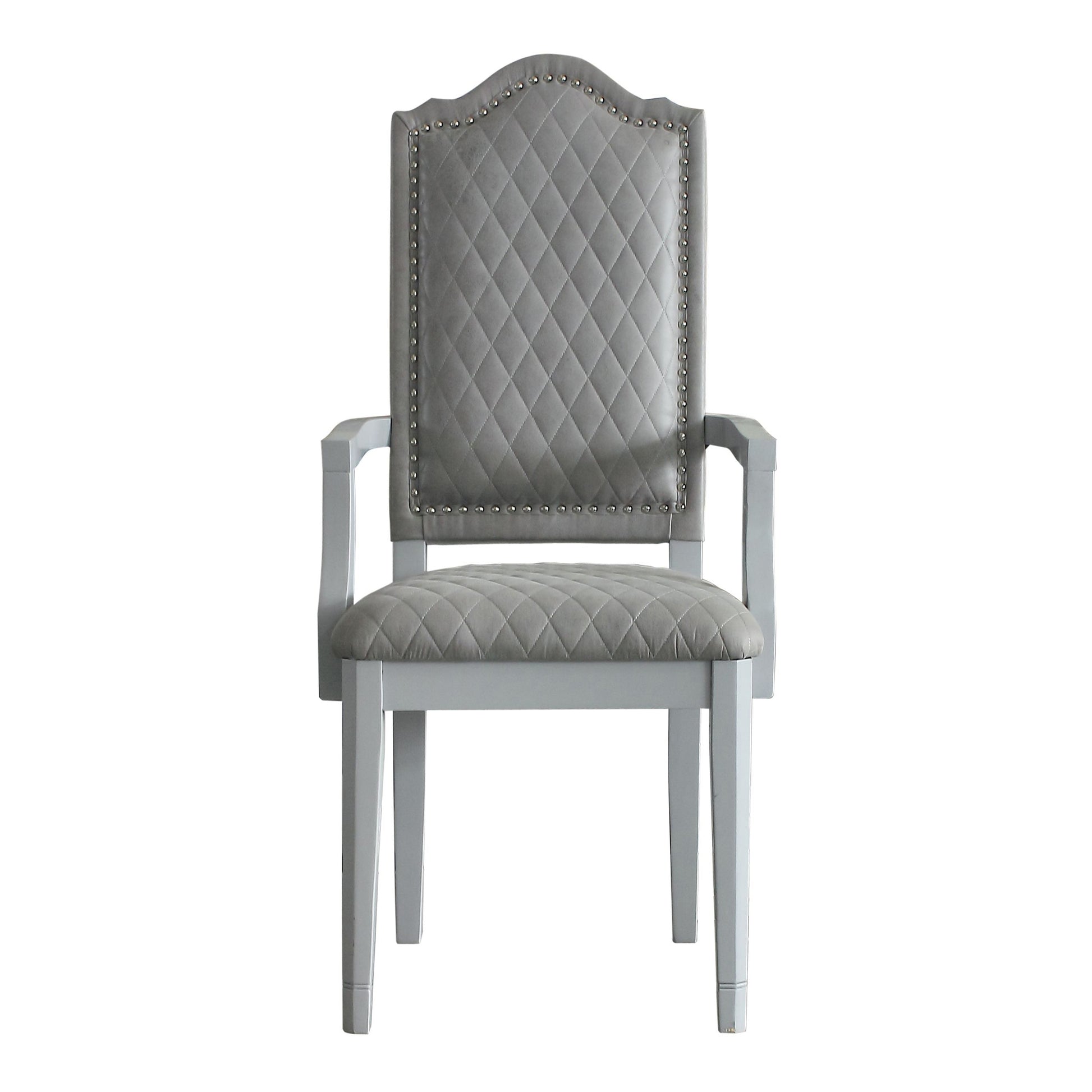 Grey upholstered armchair with tufted back and studded trim perfect for dining rooms
