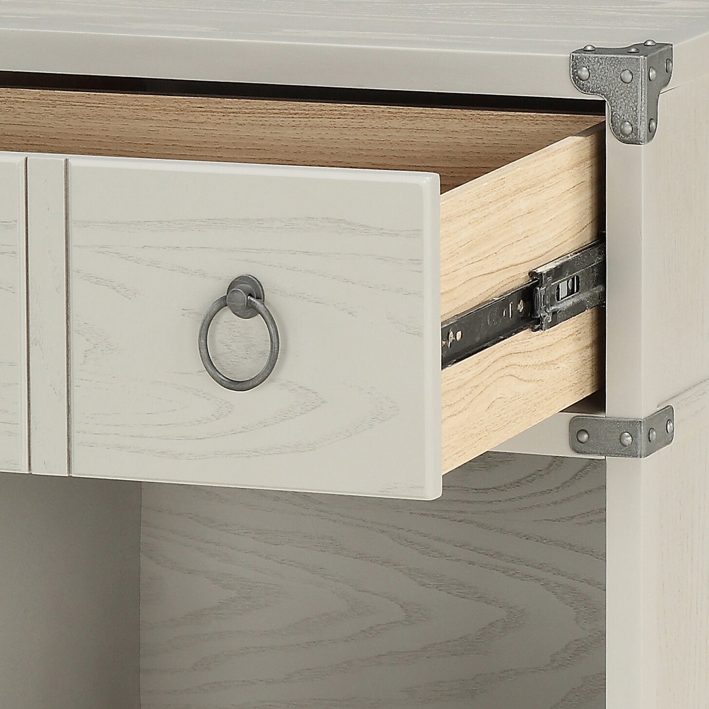 Light cream dresser drawer with metal ring pull exposed wood interior and drawer slide