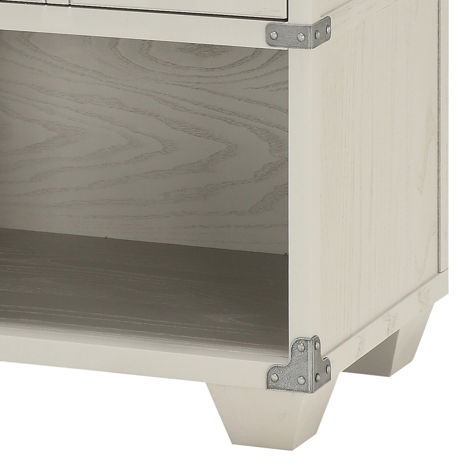 Close up of distressed white wood grain shelf interior with metal corner brackets on antiquestyle nightstand