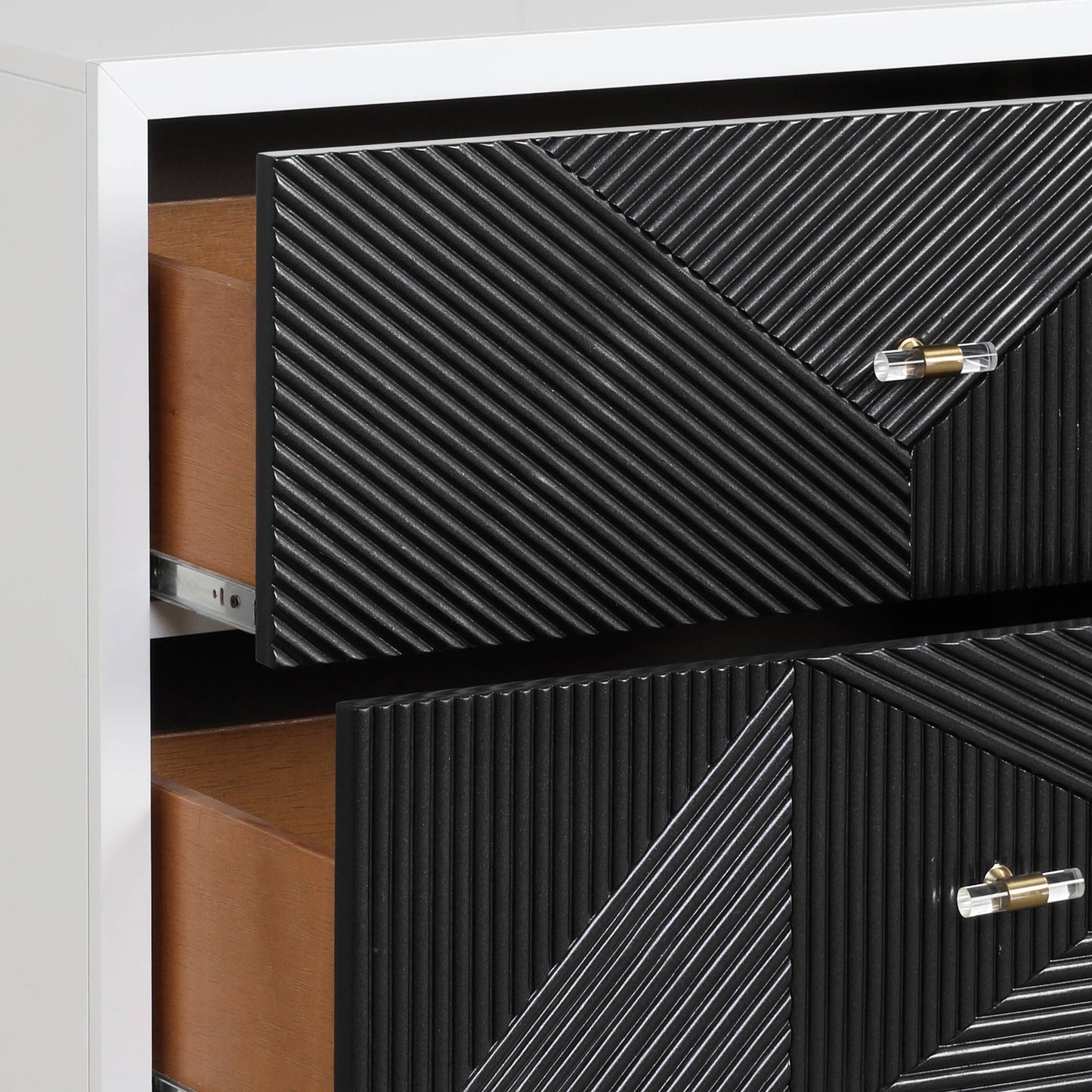 Black textured dresser with brass and crystal hardware two drawers open showing wood interiors