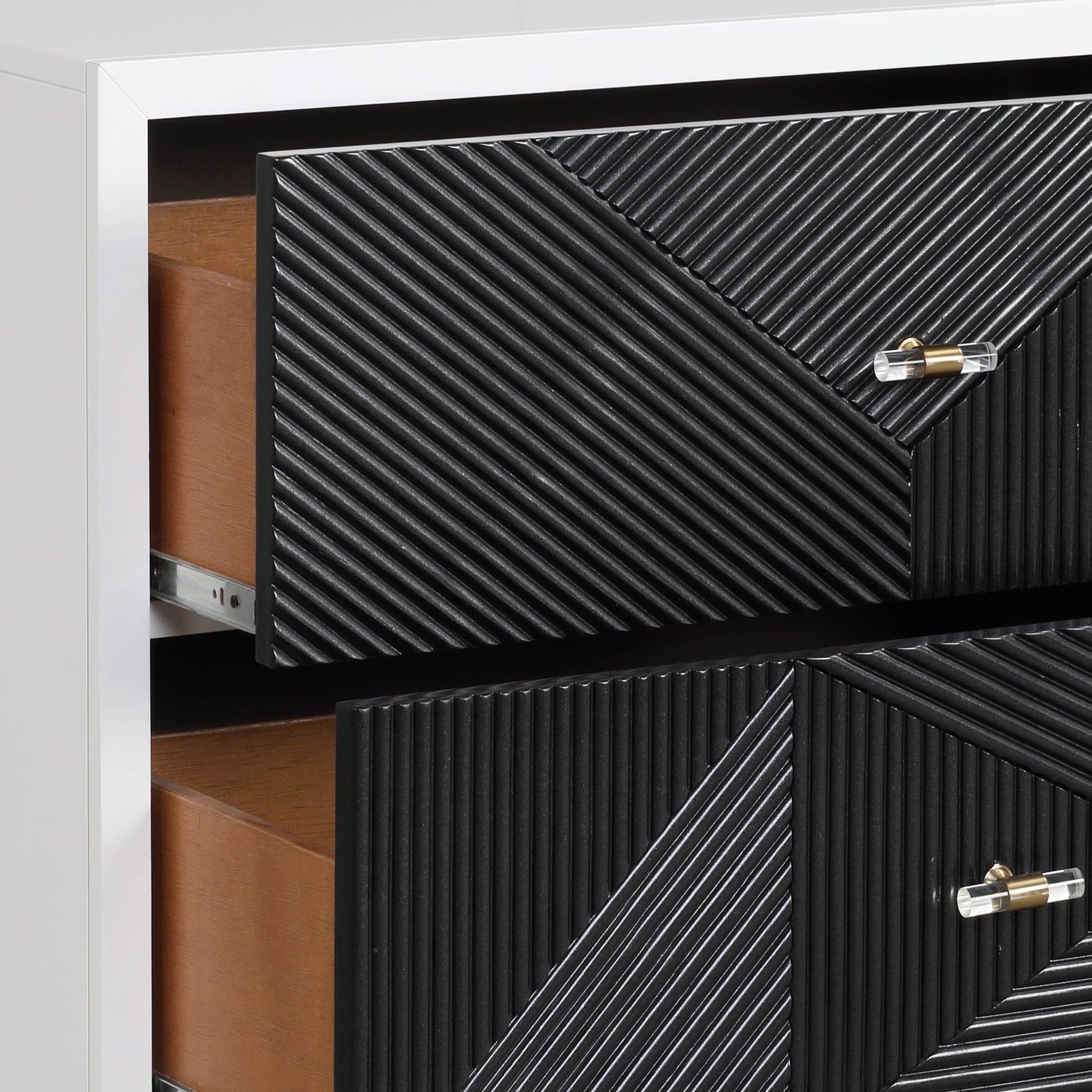 Black textured dresser with brass and crystal hardware two drawers open showing wood interiors