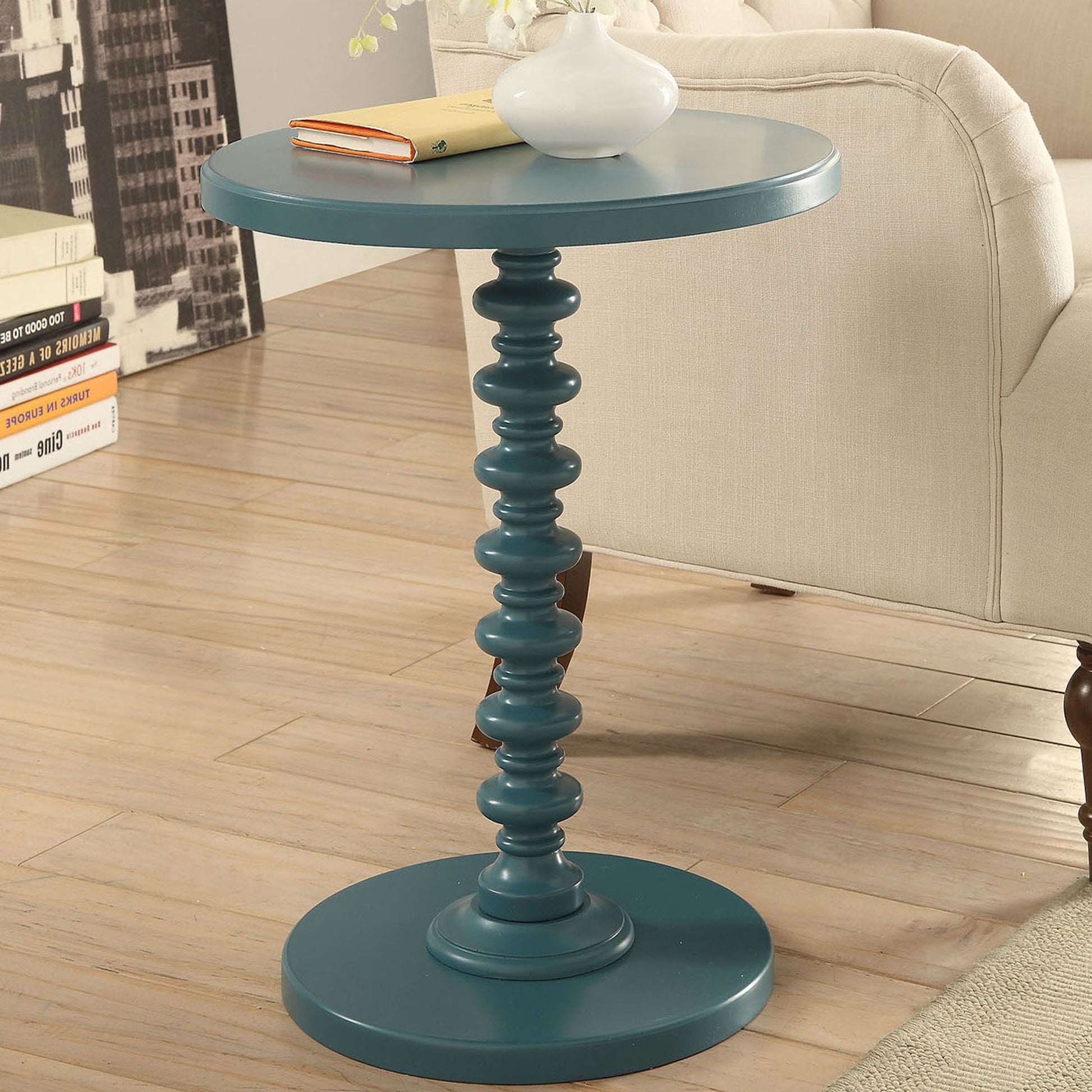 Teal round accent table with carved pedestal base perfect for living rooms