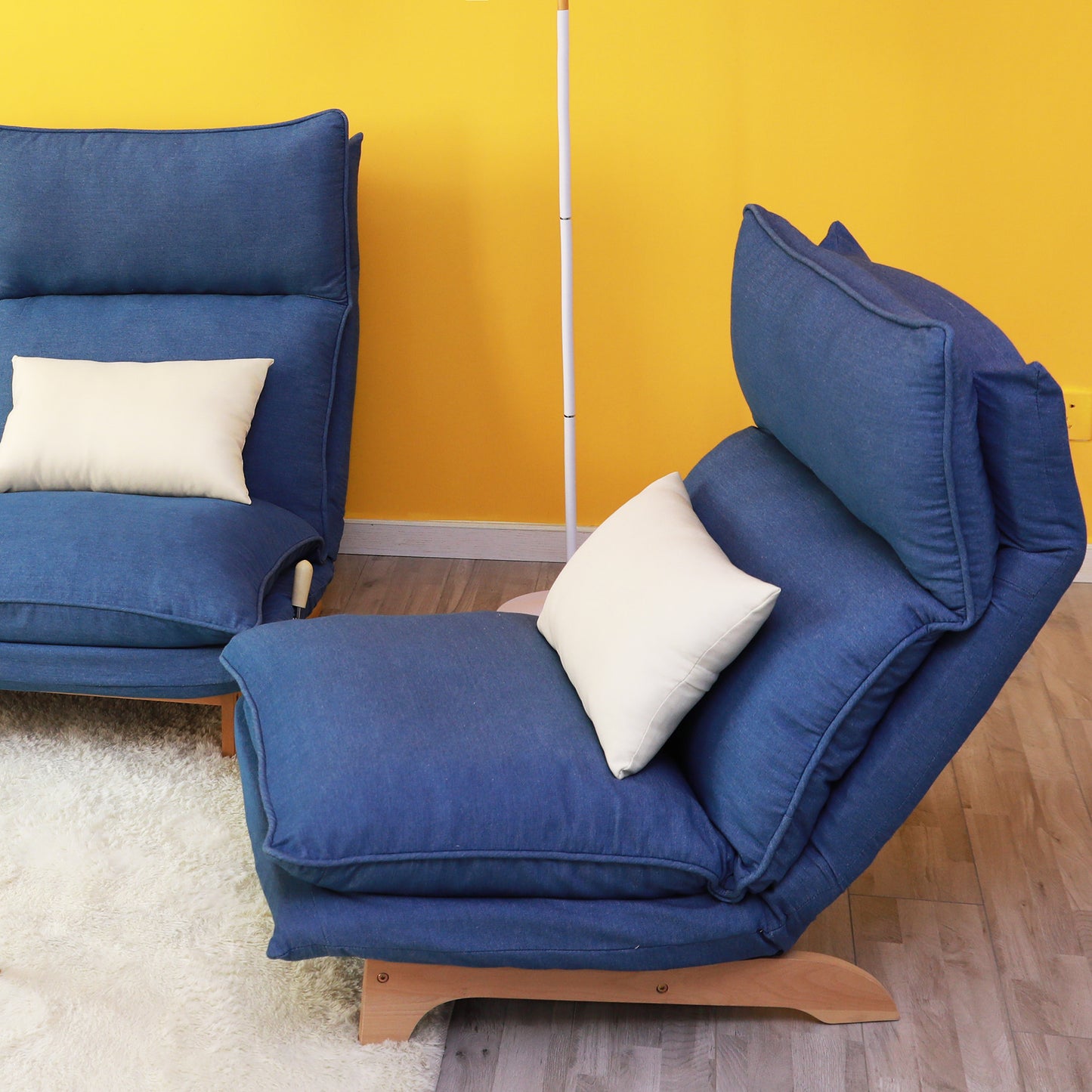 Blue denim sofa chair with adjustable backrest and cream accent pillow
