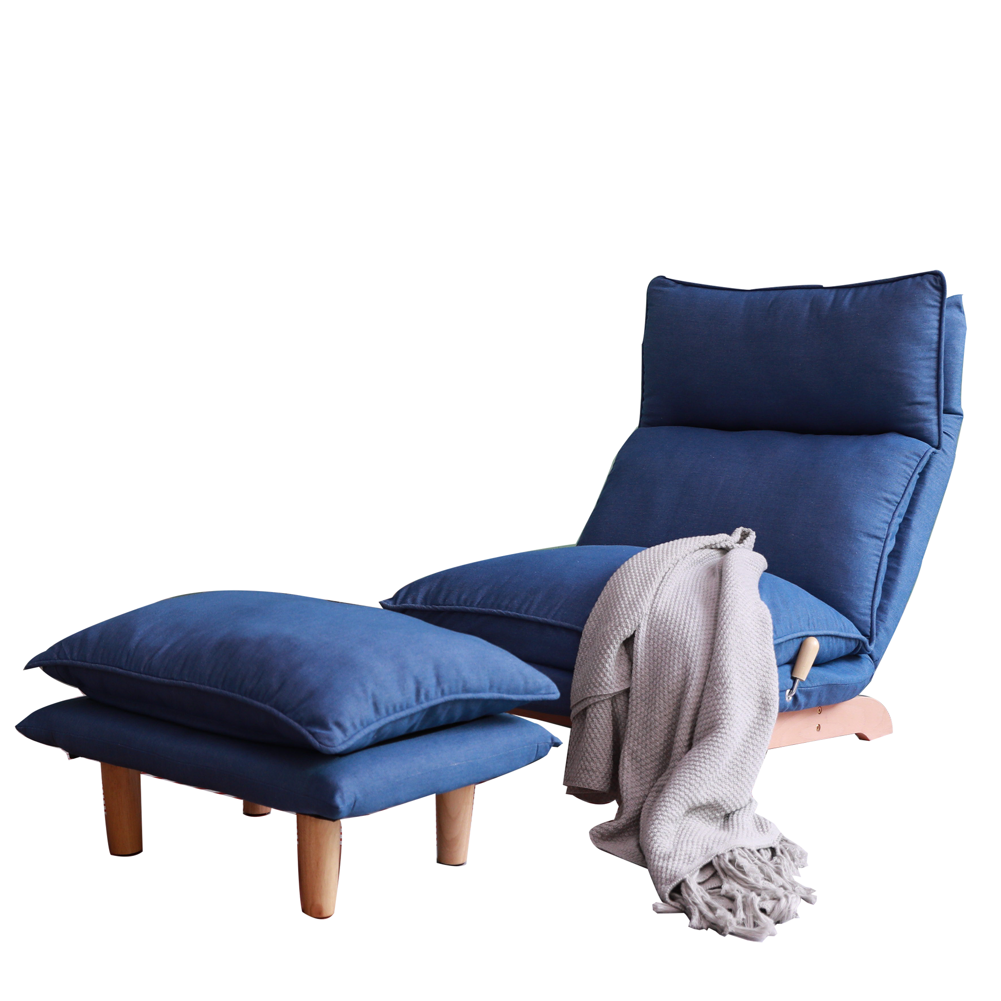 Navy blue upholstered lounge chair with wooden legs and matching ottoman draped with a grey throw
