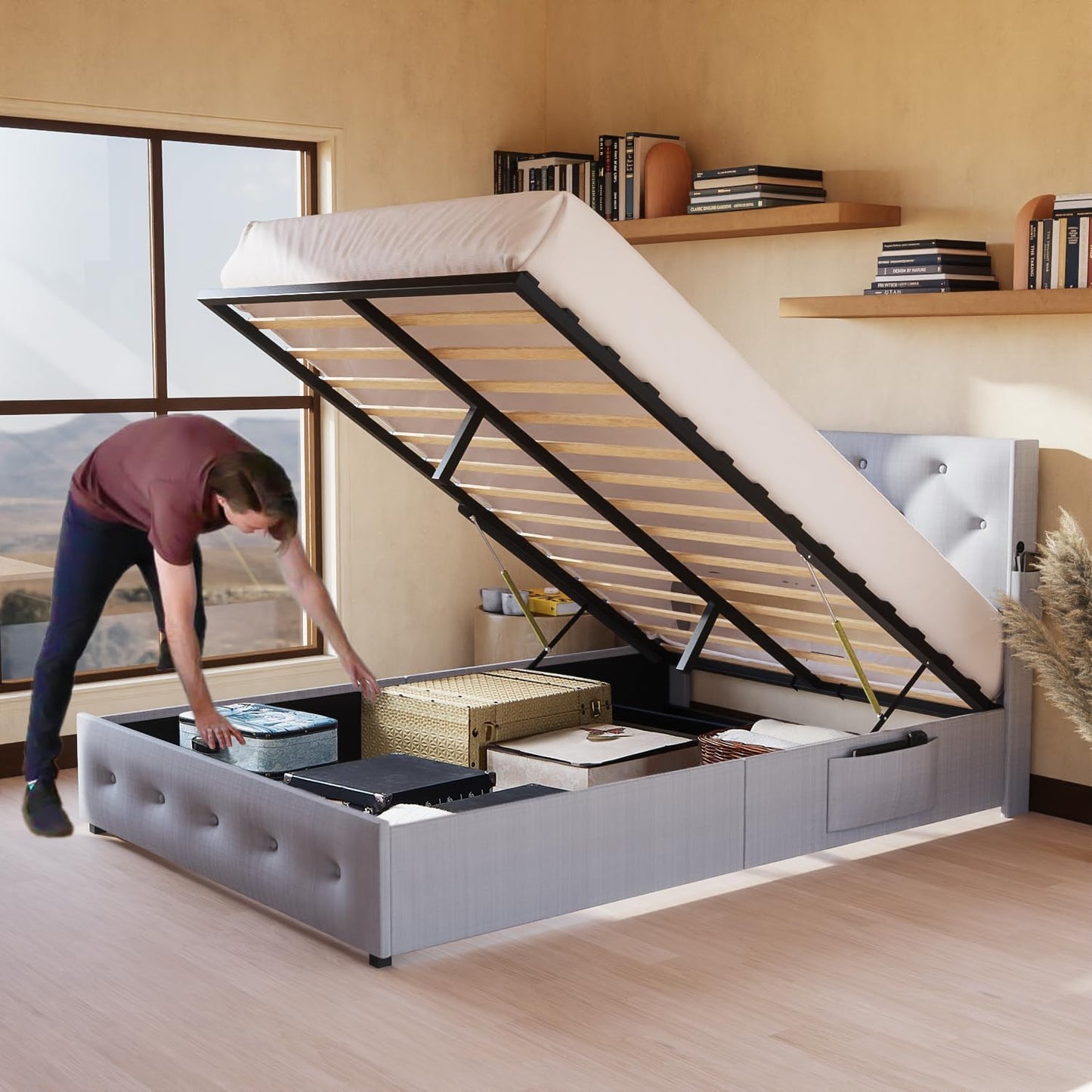 Grey upholstered storage bed frame with liftup mattress revealing ample storage for linens and luggage