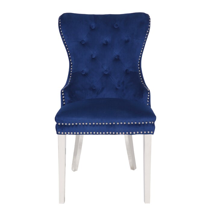 Elegant navy velvet dining chair with tufted back and silver nailhead trim