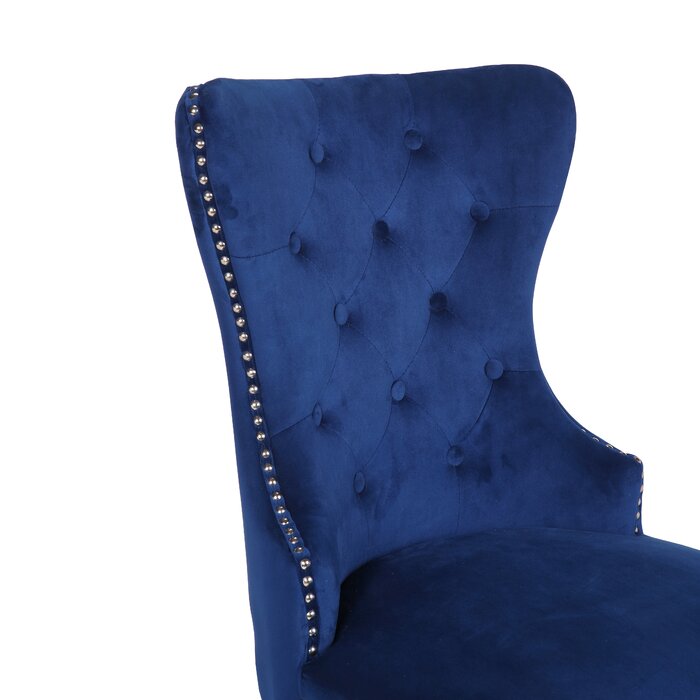 Deep blue velvet accent chair with diamond tufting and silver nailhead trim