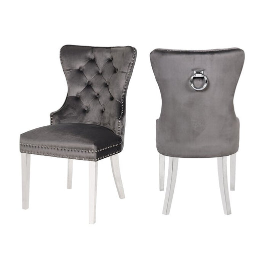 Two luxurious gray velvet dining chairs with button tufting and silver nailhead trim