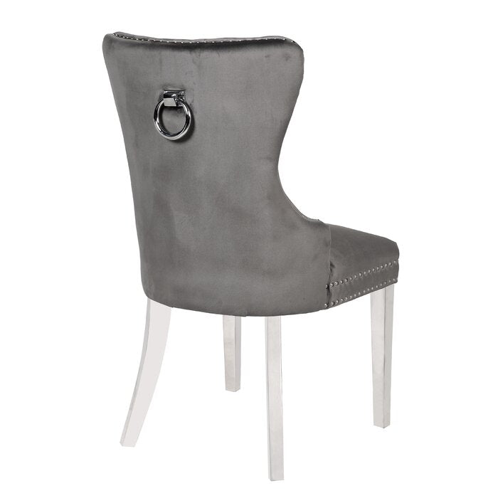 Grey velvet dining chair with silver ring pull and stud detailing