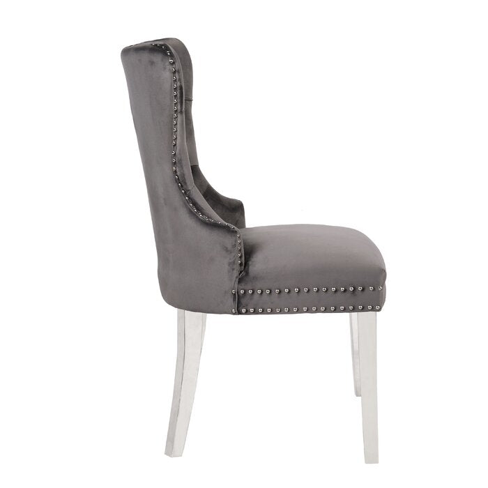Grey velvet dining chair with silver stud accents and chrome legs elegant tufted backrest