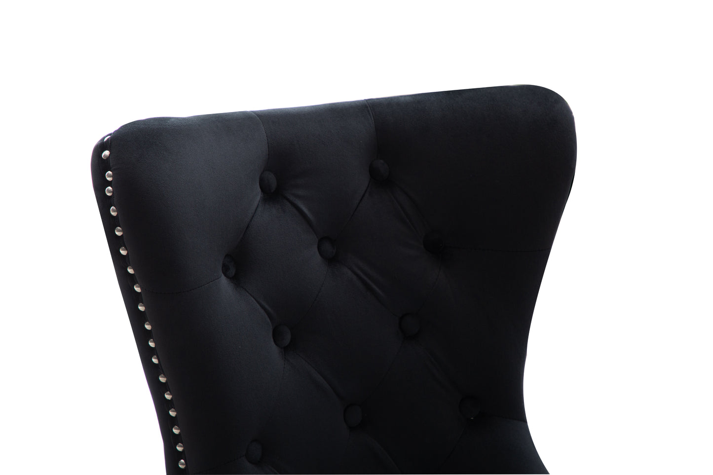 Black velvet wingback chair with silver nailhead trim and deep button tufting