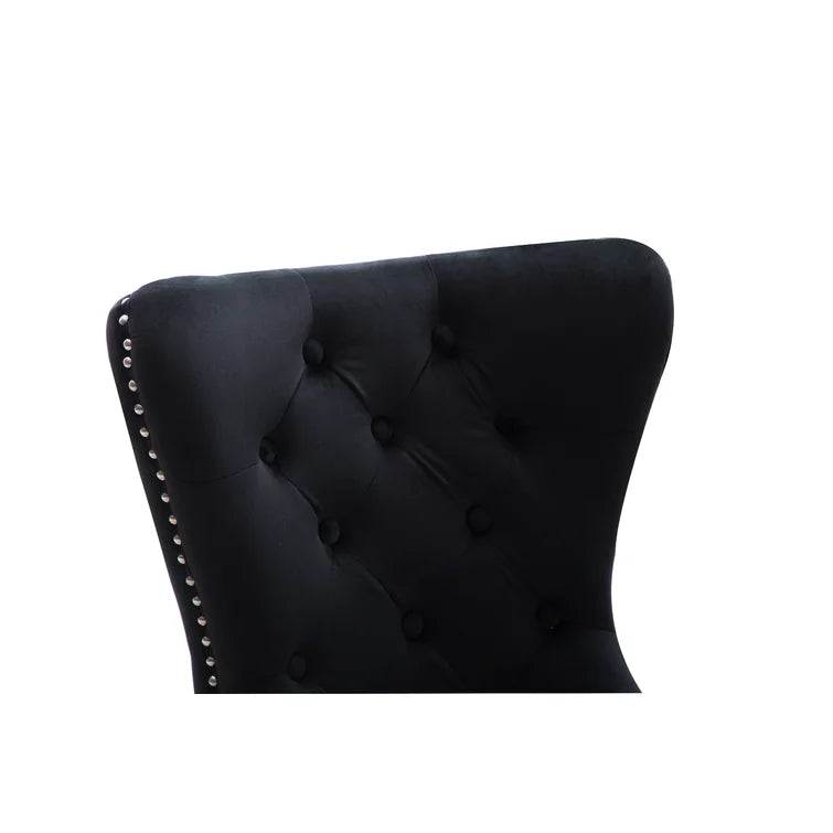 Black velvet tufted wingback chair with silver nailhead trim detail