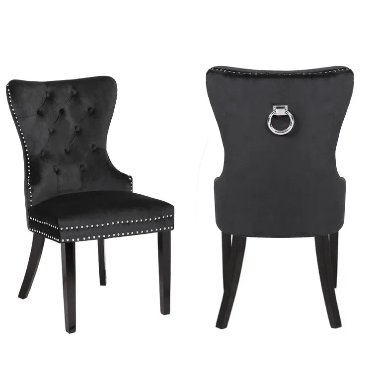 Tufted black velvet dining chair with silver nailhead trim and ring pull