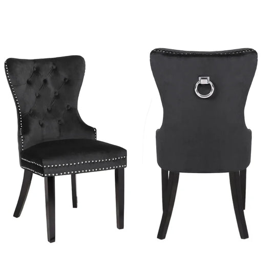 Tufted black velvet dining chair with silver nailhead trim and ring pull